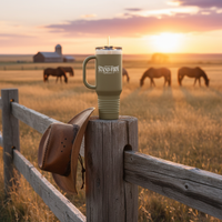 Olive Stand Firm tumbler on fence post at ranch with horses at sunset